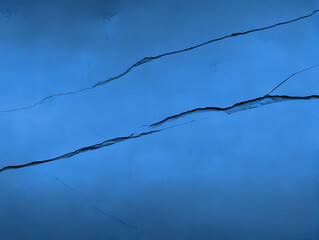 Cracked Blue Surface shows Fracture Lines Across a Smooth Background with Minimalist Design.