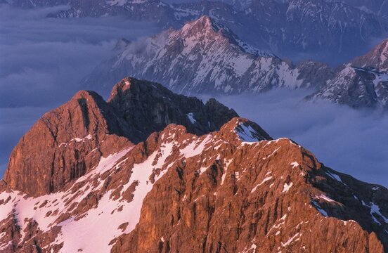 View from the summit of Mount Zugspitze, mountain peaks bathed in pink evening light, Bavaria, Germany, Europe