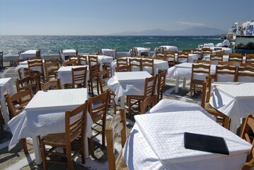 Tables at a restaurant on the waterfront in Mykonos, Cyclades, Greece, Europe