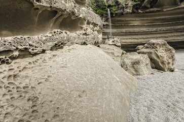 Rock formations of Truman's Cove at the beach with a waterfall, Te Miko, Truman's Bay, Paparoa National Park, Punakaiki, South Island, New Zealand, Oceania