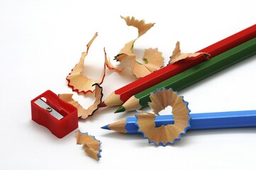 Wooden coloured pencils, sharpened with a sharpener and shavings