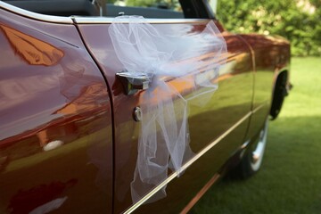 Tulle netting, veil tied to a Cadillac, wedding