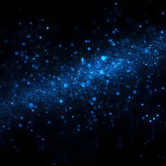 Fototapeta premium Abstract blue glitter sparkles on a dark background, creating a magical and festive atmosphere.