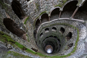 Naklejka premium Spiral staircase in the well of initiation in mystical castle Quinta da Regaleira, Sintra.