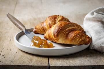 freshly baked croissants on wooden rustic kitchen table