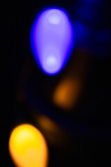 Blurred Christmas lights against black background