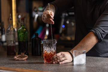 Bartender preparing alcohol cocktail in a glass