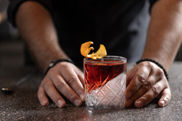Bartender preparing alcohol cocktail in a glass