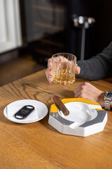 Close up of man hands holding whiskey glass