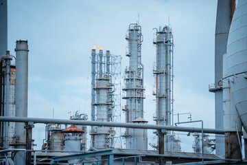 Industrial facilities showcase towering structures under a cloudy sky in an energy production setting