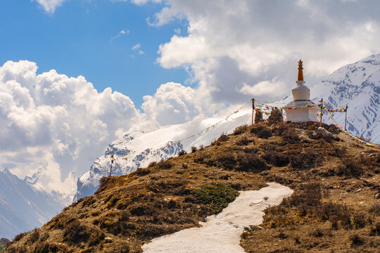 View of Buddhist gompa and Paungda Danda mountain in Himalayas, Annapurna Conservation Area, Nepal. Snow capped mountains. Annapurna Circuit Trek. Hiking trekking concept. Tibetan Buddhism