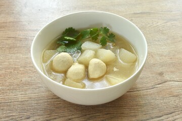 boiled slice radish with pork ball in clear bone soup on bowl