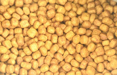 close up of dry cat food in aluminum foil bag packging background and texture