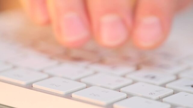 Extreme close up of hands typing quickly on a keyboard, reflecting the process of preparing professional reports and documentation with accuracy and efficiency.