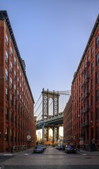View from Main Street to Manhattan Bridge and Empire State Building, with morning sun, Dumbo,...