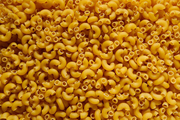 close up raw yellow italian pasta background 