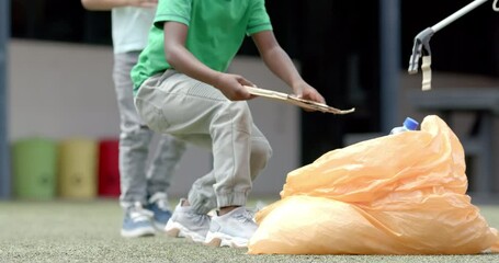 Picking up trash, children cleaning school playground, promoting environmental care