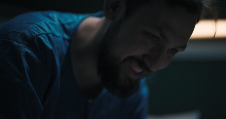 Man with mental health issues is laughing uncontrollably in his hospital bed.