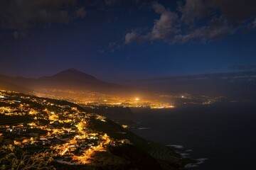 View of illuminated city Puerto de la Cruz, city view, Pico del Teide at night, north coast...
