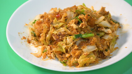 stir fried sukiyaki with egg and pork on white plate