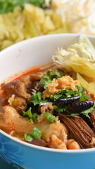 rice vermicelli with northern thai curry sauce on blue background