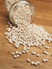 White beans in a canning jar on a kitchen table, healthy organic food concept