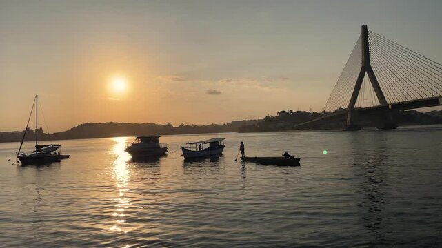 Seascape with river, cable-stayed bridge, boats and sunset in Ilh&eacute;us in Bahia