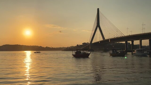 Seascape with river, cable-stayed bridge, boats and sunset in Ilh&eacute;us in Bahia