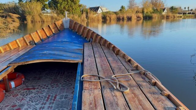 boat trip on a lake in a wooden boat in a protected area on a sunny day at sunset