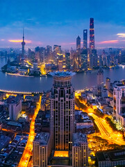 Obraz premium Aerial view of Shanghai skyline and bright city streets at dawn
