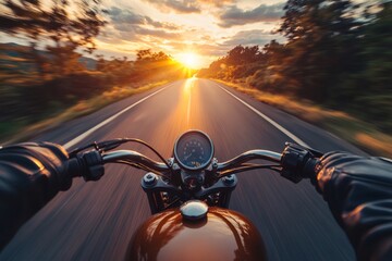 Naklejka premium Motorcyclist driving into the sunset on a country road