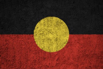 Australian Aboriginal flag painted on the cracked grunge concrete wall