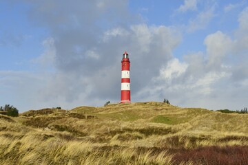 Red and white lighthouse on sand dune, clouds, Amrum, North Frisia, Schleswig-Holstein, Germany, Europe