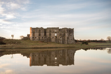 Carew Castle  at sunrise, with reflections