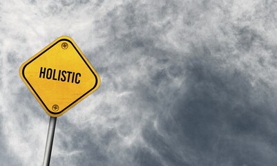 Holistic, yellow sign with cloudy sky