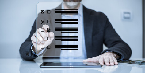 Man do online exam on virtual screen. Answer a survey filling out a tech form. Quiz, test concept