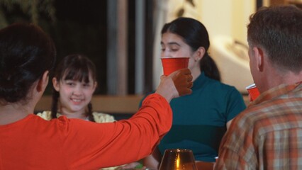 Family gather celebrate holiday. Parents, grandparents and girl together to talk and have dinner party food. Outdoor activity for spending time with multigeneration cross generation gap. Divergence.