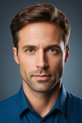 Fototapeta premium arafed man in blue shirt looking at camera with serious look
