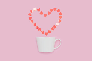 Creative minimalist composition of a white coffee cup releasing a heart-shaped arrangement of heart confetti, set against a pink background, symbolizing love and warmth.