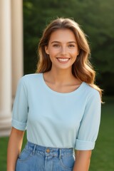 smiling woman in blue top and jeans standing in front of a building