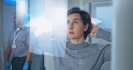 Airport Terminal: Adult Woman Walks Through Metal Detector Scanner on Security Checkpoint for...