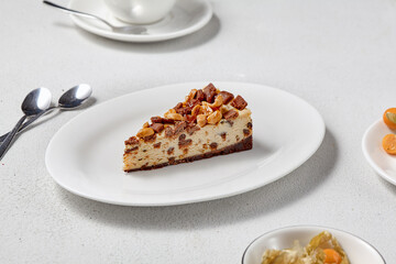 Slice of Nutty Cheesecake on Minimalist White Table