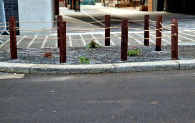 flower bed, treeline, lattice, with a circular hole for a tree trunk that is in middle of a cobbled...