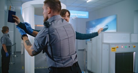 Airport Terminal: Man Walks Through Metal Detector Gates on Security Checkpoint. Security Officer...