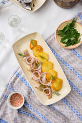 Rustic Elegance Baked Potatoes with Salted Herring on a Cozy Table Setting