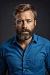 Fototapeta premium arafed man with a beard and a blue shirt looking at the camera