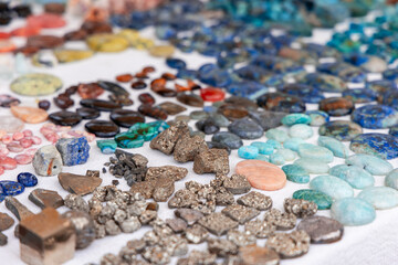Vibrant stones, including raw pyrite, lapis lazuli, malachite, and aquamarine, arranged alongside...