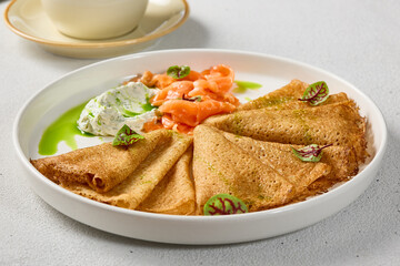 Gourmet Salmon and Cream Cheese Pancakes on Elegant White Plate with Delicate Composition
