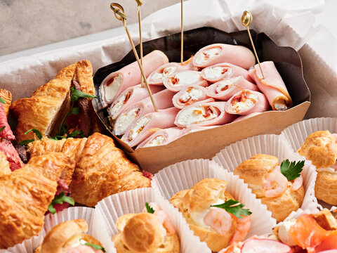A variety of freshly baked croissants and savory rolls are presented on a platter, ideal for a breakfast gathering. The warm colors and inviting presentation create a cozy atmosphere