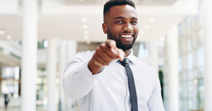 Pointing, portrait and smile of business black man in lobby of office for choice, opportunity or vote. Deal, recruitment and success with happy employee in workplace to select you as winner of bonus